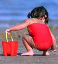 family vacations in florida, girl playing on beach, digging in the sand, naples florida, florida beaches